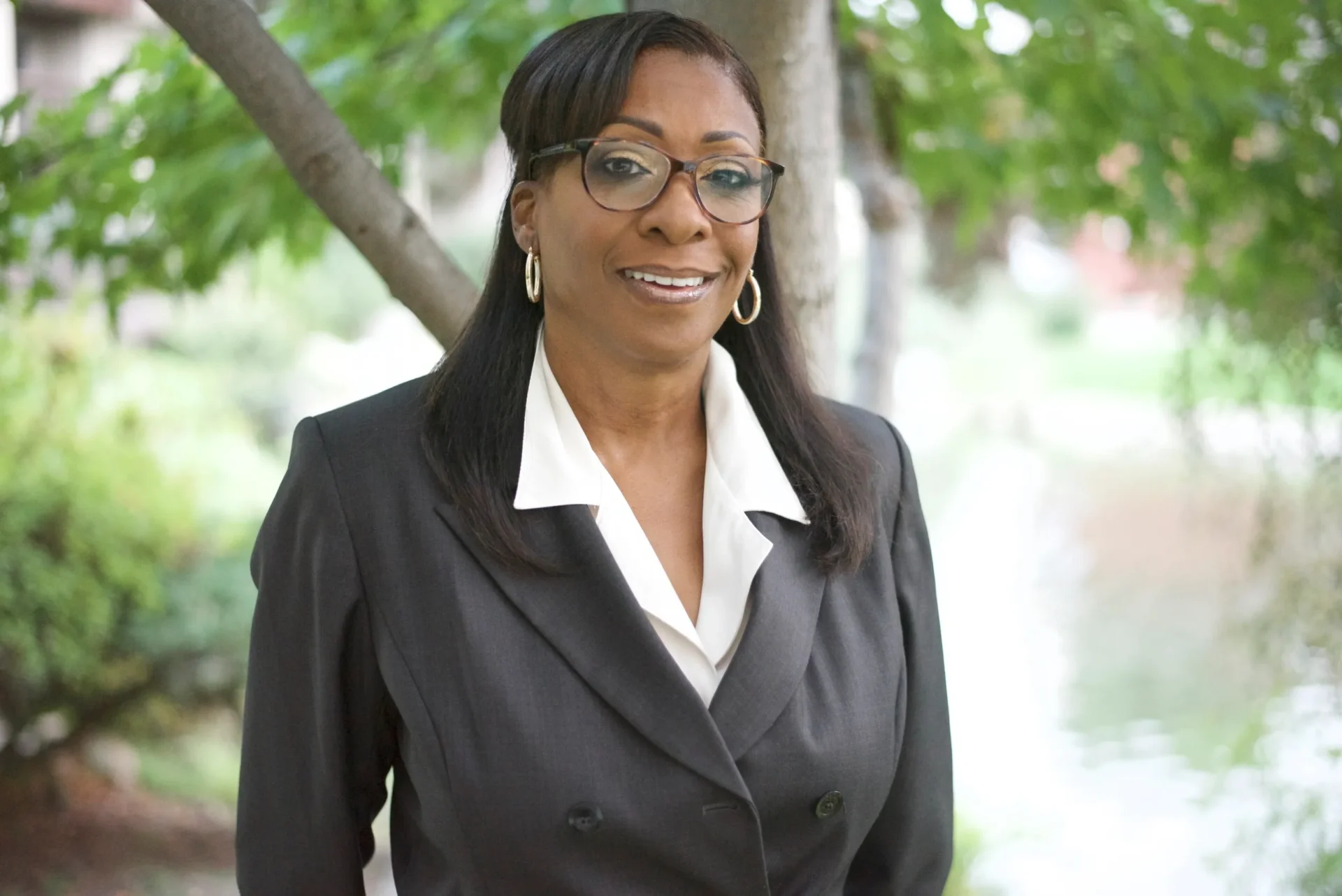 A woman in a black suit and white shirt.