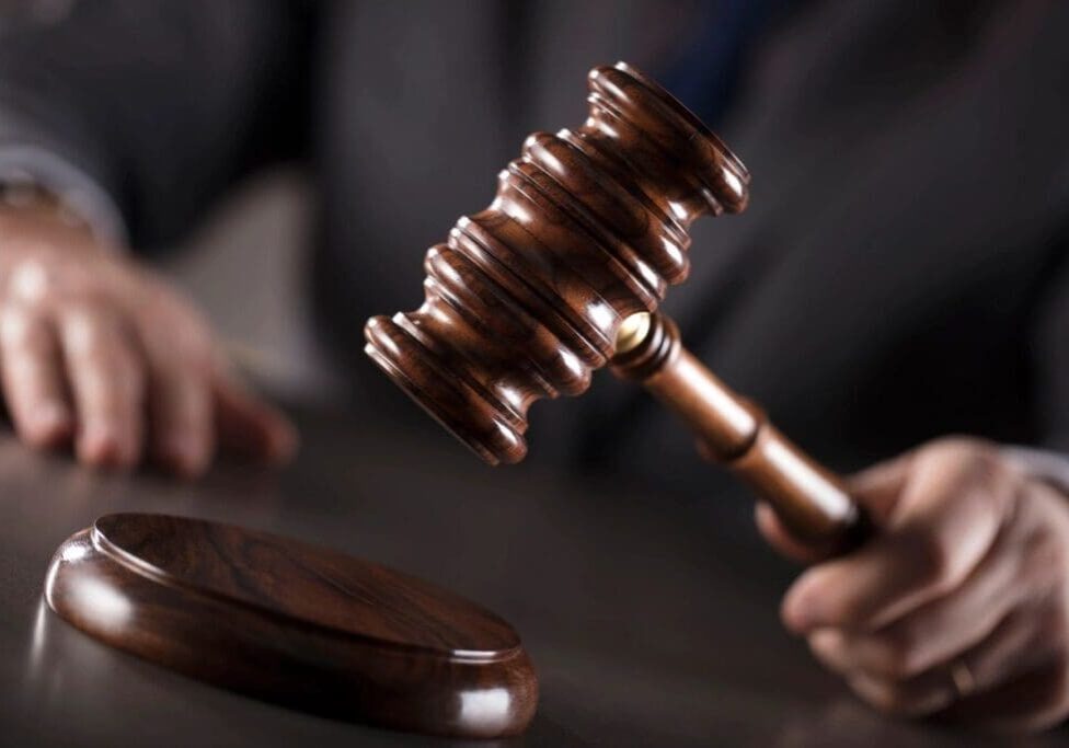 A person holding a gavel in their hand.