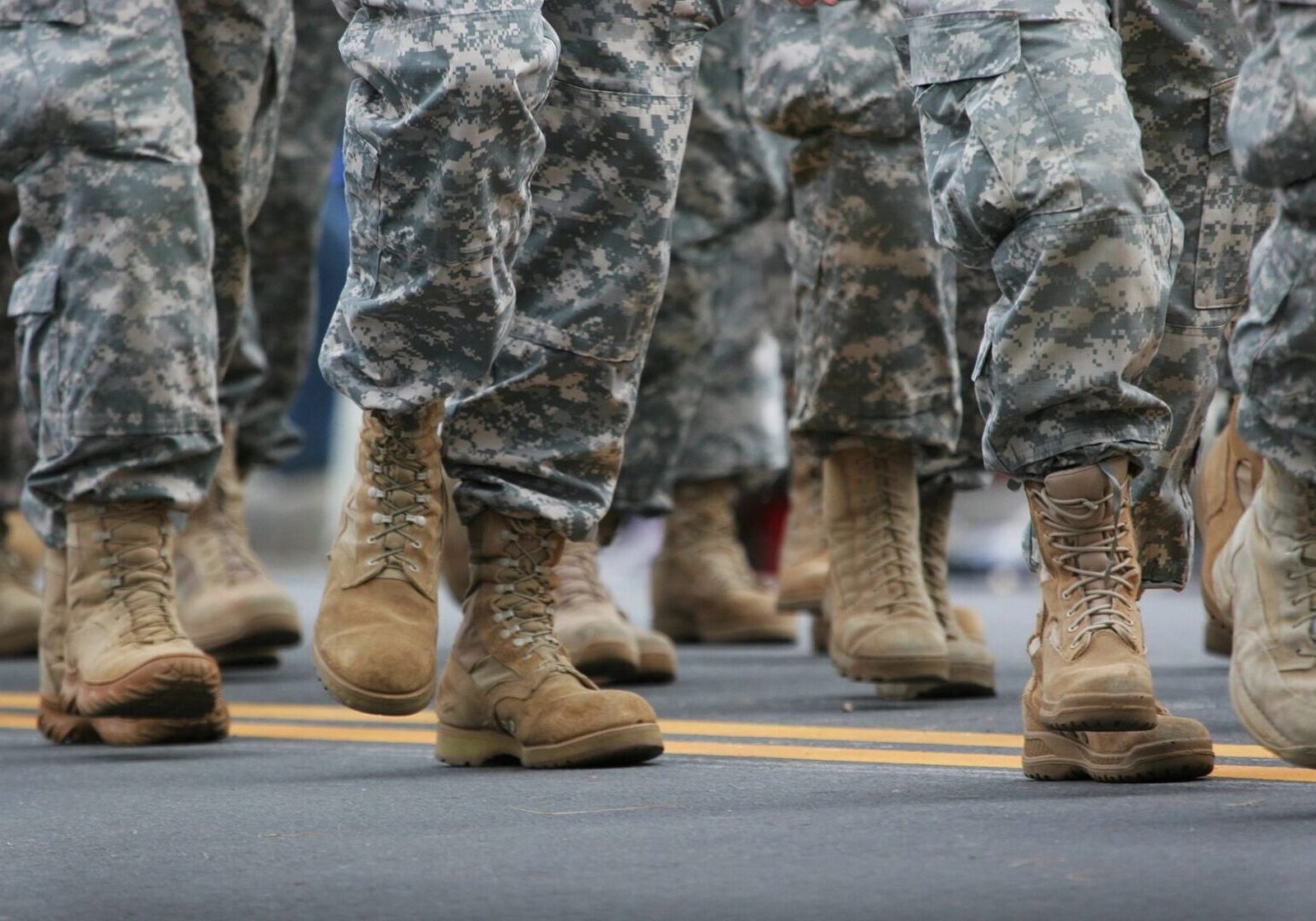 A close up of soldiers in camouflage boots