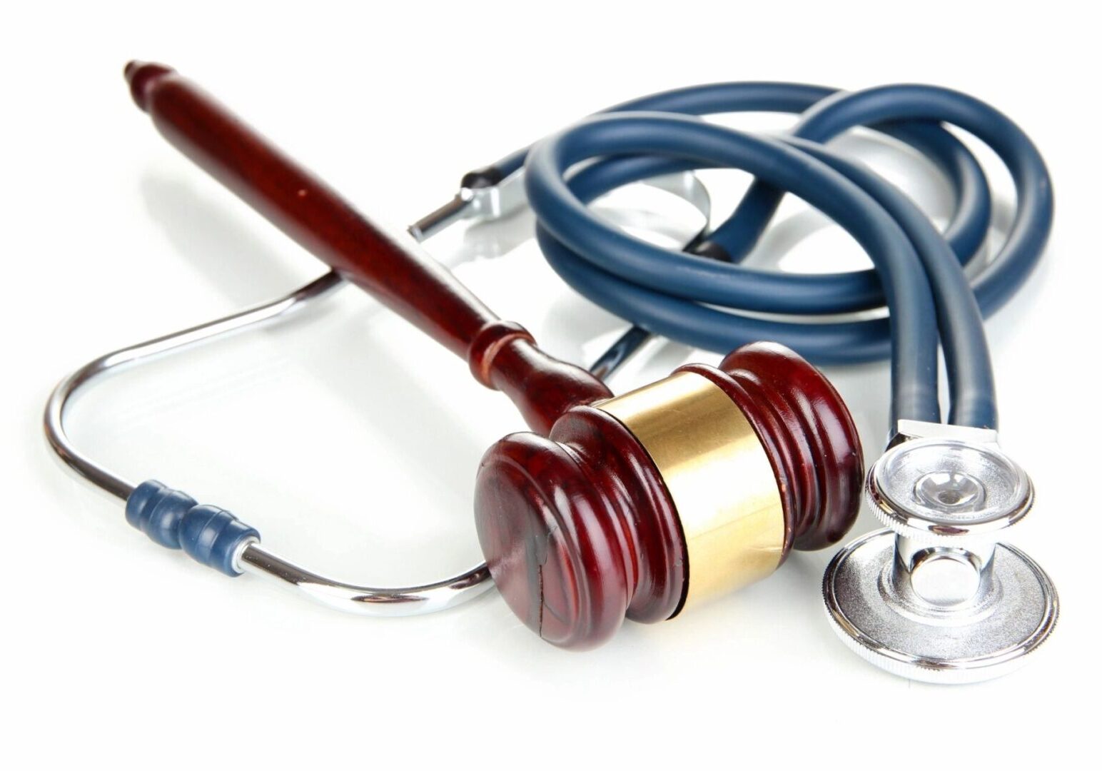 A judge 's gavel and stethoscope on top of the table.